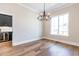 Dining room featuring hardwood floors, a modern chandelier, and a butler's pantry at 162 Farmstead Ct, Wendell, NC 27591