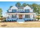 Charming two-story modern farmhouse featuring a welcoming front porch and beautifully landscaped front yard at 162 Farmstead Ct, Wendell, NC 27591