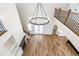Staircase and two-story foyer with hardwood floors and modern chandelier at 162 Farmstead Ct, Wendell, NC 27591