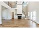 Bright, open living room features a fireplace, two story foyer and staircase with wooden floors at 162 Farmstead Ct, Wendell, NC 27591