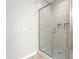 Modern bathroom featuring a glass-enclosed shower with built-in niches and neutral tile at 1711 Memory Ln, Burlington, NC 27217