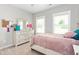 Cozy bedroom featuring a neutral color palette and a comfortable-looking bed with stylish pink bedding at 1711 Memory Ln, Burlington, NC 27217