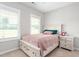 Serene bedroom showcasing a comfortable bed, soft neutral tones, and plenty of natural light through the window at 1711 Memory Ln, Burlington, NC 27217