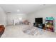 Expansive bonus room featuring a cozy seating area, a large TV, and a playful dollhouse, ideal for versatile use at 1711 Memory Ln, Burlington, NC 27217