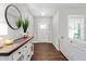Elegant entryway with hardwood floors, stylish console table, and a view into the adjacent living area at 1711 Memory Ln, Burlington, NC 27217