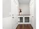 Hallway featuring built-in dog kennel and dark wood floors at 1711 Memory Ln, Burlington, NC 27217