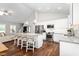 Spacious kitchen with white cabinets, stainless steel appliances, granite countertops, and bar stool seating at 1711 Memory Ln, Burlington, NC 27217