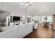 Open-concept living room with hardwood floors, neutral tones, and seamless flow to the kitchen and dining areas at 1711 Memory Ln, Burlington, NC 27217