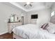 Inviting main bedroom features a tray ceiling, neutral decor, and ample natural light at 1711 Memory Ln, Burlington, NC 27217