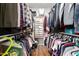 Organized walk-in closet featuring double hanging rods, shelving, and shoe storage at 1711 Memory Ln, Burlington, NC 27217
