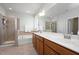 Bathroom with double sink vanity, soaking tub, glass-enclosed shower, and neutral tile at 1724 Capstone Dr, Durham, NC 27713