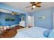 Spacious bedroom features wood floors, ceiling fan, and light blue walls at 1724 Capstone Dr, Durham, NC 27713