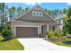 Charming home featuring a two-car garage, well-maintained lawn, and beautifully landscaped front yard at 1724 Capstone Dr, Durham, NC 27713
