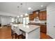 Open-concept kitchen with granite countertops, stainless steel appliances, and a breakfast bar at 1724 Capstone Dr, Durham, NC 27713