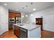 Open-concept kitchen with granite countertops, stainless steel appliances, and a breakfast bar at 1724 Capstone Dr, Durham, NC 27713