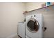 Functional laundry room with modern washer and dryer units and shelving at 1724 Capstone Dr, Durham, NC 27713