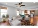 Open-concept living room with a hardwood floor, ceiling fan, and a glimpse into the kitchen at 1724 Capstone Dr, Durham, NC 27713