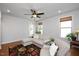 Cozy living room features neutral walls, hardwood floors, large windows and a ceiling fan at 1724 Capstone Dr, Durham, NC 27713