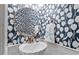 Stylish powder room with a modern vanity, gold faucet, decorative mirror, and elegant tulip-themed wallpaper at 19 Knightsbridge Ct, Durham, NC 27707