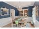 Elegant dining room with wainscoting, a beaded chandelier, and a round wooden table at 19 Knightsbridge Ct, Durham, NC 27707