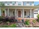 Inviting front porch with brick flooring, decorative plants, and charming seating arrangements at 19 Knightsbridge Ct, Durham, NC 27707