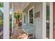 Close up shot of a charming covered front porch with detailed trim, and a comfortable bench at 19 Knightsbridge Ct, Durham, NC 27707