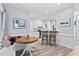 Cozy kitchen features a built in breakfast nook, white cabinets, stainless appliances, and warm wood-look flooring at 19 Knightsbridge Ct, Durham, NC 27707