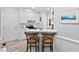 Bright kitchen boasts white cabinets, a subway tile backsplash, stainless appliances, and breakfast bar with seating at 19 Knightsbridge Ct, Durham, NC 27707