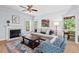 Relaxing living room with a fireplace, comfortable seating, and a doorway leading to the outdoor screened porch at 19 Knightsbridge Ct, Durham, NC 27707