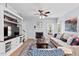 Inviting living room showcasing a fireplace, built-in storage, a plush sofa, and a view of the outdoor scenery at 19 Knightsbridge Ct, Durham, NC 27707