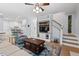 Open living room featuring a staircase, built-in shelving, and a seamless transition to the kitchen area at 19 Knightsbridge Ct, Durham, NC 27707