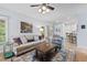 Comfortable living room with a cozy seating arrangement, stylish decor, and a view towards the dining area and screened porch at 19 Knightsbridge Ct, Durham, NC 27707