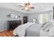 Primary bedroom featuring wood floors, neutral walls, and white trim, with a dark wood dresser and ample natural light at 19 Knightsbridge Ct, Durham, NC 27707
