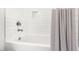 Bright bathroom with a white subway tile tub and shower combo with a shower curtain at 1928 Vandiver Way, Apex, NC 27523