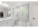 Modern bathroom showcasing a glass shower with built-in bench and niche, marble floors, and double vanity at 1928 Vandiver Way, Apex, NC 27523