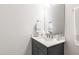 Modern bathroom showcasing a vanity with quartz countertop, cabinet and a large mirror at 1928 Vandiver Way, Apex, NC 27523