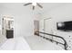 Comfortable bedroom with neutral colors and soft carpet with an adjacent bathroom with double doors at 1928 Vandiver Way, Apex, NC 27523