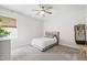 Bright bedroom featuring plush carpet, a ceiling fan, and a cozy bed with neutral tones at 1928 Vandiver Way, Apex, NC 27523