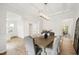 Bright dining room features an open floor plan, wood floors, stylish lighting, and modern furnishings at 1928 Vandiver Way, Apex, NC 27523