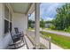 Cozy front porch featuring comfortable rocking chairs and views of the charming neighborhood street at 1928 Vandiver Way, Apex, NC 27523