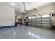 Large garage featuring epoxy floors, high ceilings, and ample space for parking and storage with overhead door at 1928 Vandiver Way, Apex, NC 27523