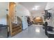 Spacious garage with epoxy flooring, workbench, fridge, and stairs to living area, perfect for projects and storage at 1928 Vandiver Way, Apex, NC 27523