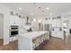 Spacious kitchen featuring a large island, stainless steel appliances, and stylish pendant lighting at 1928 Vandiver Way, Apex, NC 27523
