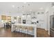 Bright kitchen with an island, stainless steel appliances, and bar stool seating, adjacent to dining area at 1928 Vandiver Way, Apex, NC 27523