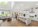 Open kitchen and living area with a large island, modern appliances, and lots of natural light at 1928 Vandiver Way, Apex, NC 27523