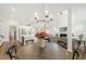 Open floor plan with a kitchen featuring a large island and breakfast bar, connecting to living and dining areas at 1928 Vandiver Way, Apex, NC 27523