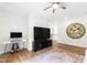 Bright living room with hardwood floors, modern desk, wall clock, TV and comfortable seating at 1928 Vandiver Way, Apex, NC 27523