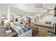 Open-concept living room showcasing a seamless transition to the modern kitchen and staircase at 1928 Vandiver Way, Apex, NC 27523
