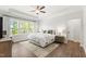 Serene main bedroom with tray ceilings, large windows, and hardwood floors at 1928 Vandiver Way, Apex, NC 27523