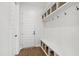 Mudroom with custom shelving, coat hooks, and bench seating for organization at 1928 Vandiver Way, Apex, NC 27523